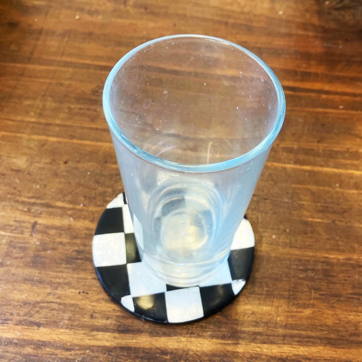 A Drink Cup resting on a coaster