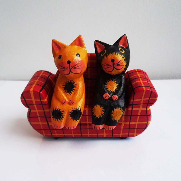 2 Wooden Cats on a Sofa